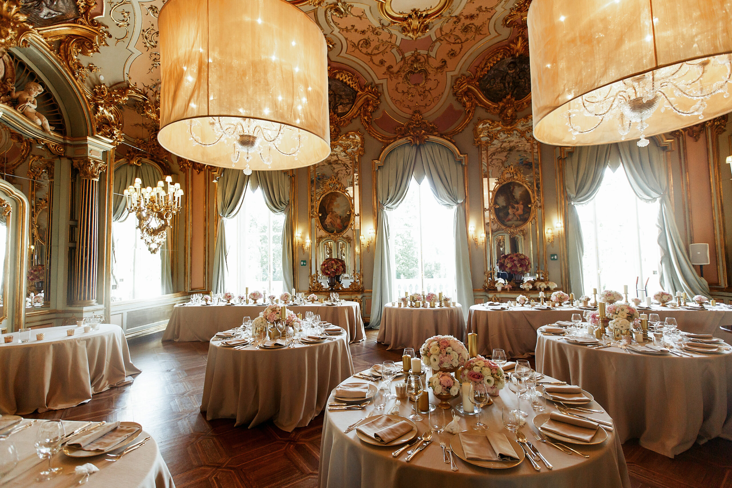 Gorgeous Italian hall with paintings on the wall and prepared for wedding dinner